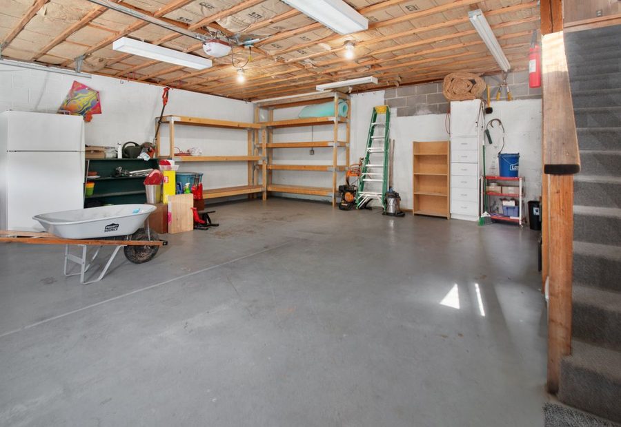 Freshly poured garage floor slab pitched toward the overhead door